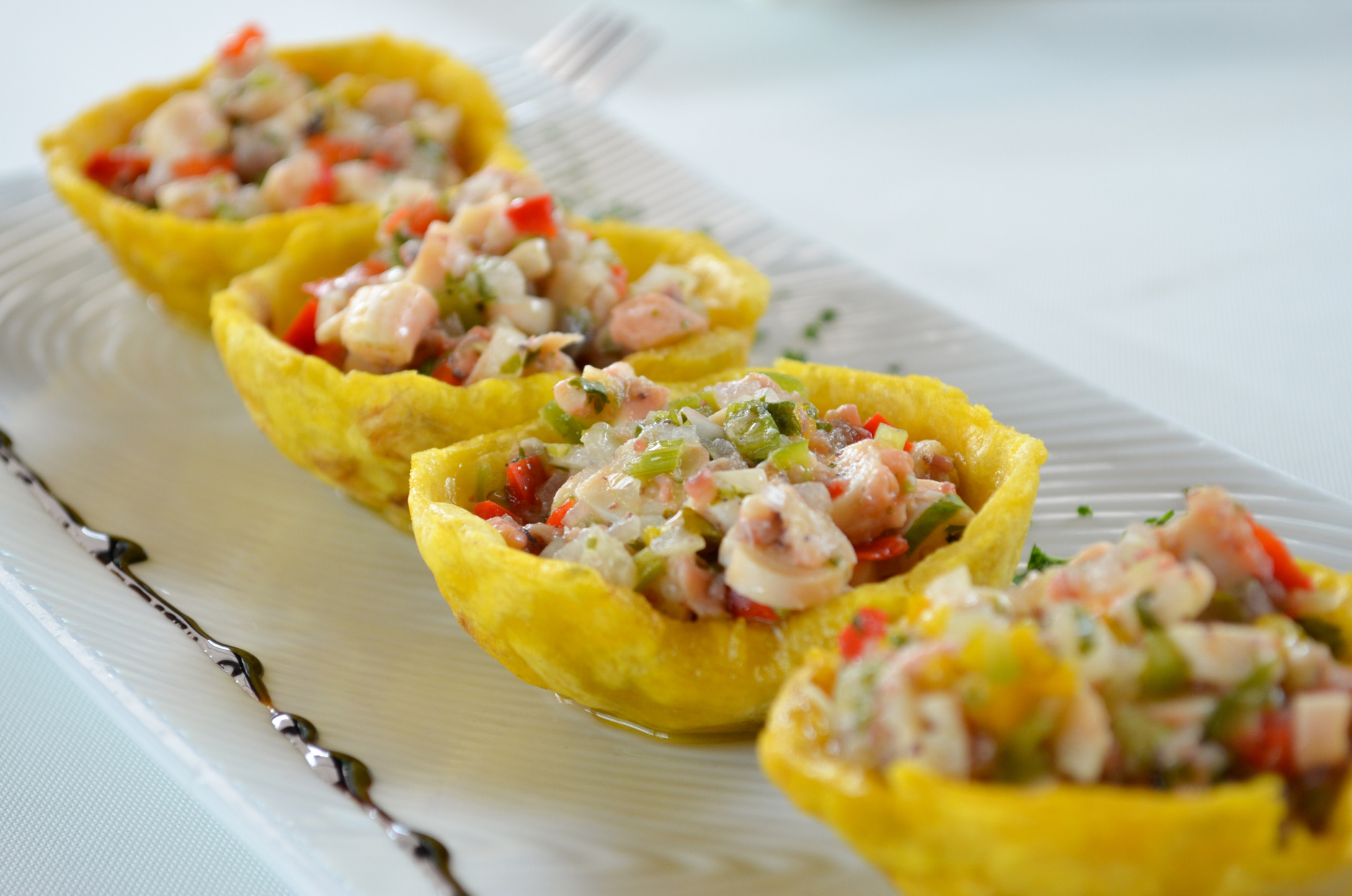 Tostones cup, made of fried green plantain, with octopus spatter